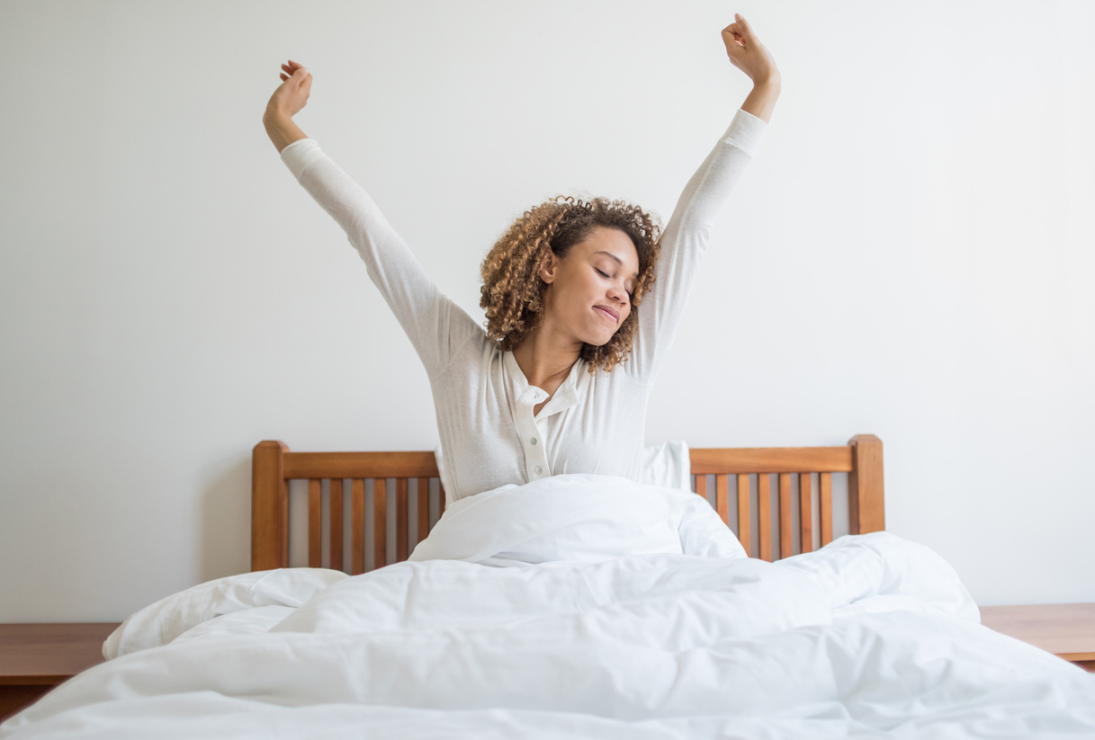 Woman yawning in bed